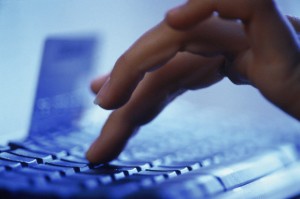 Hand typing on computer keyboard